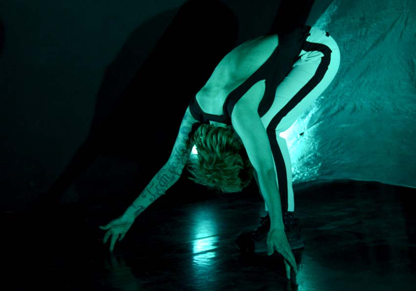 A person crouching on the stage